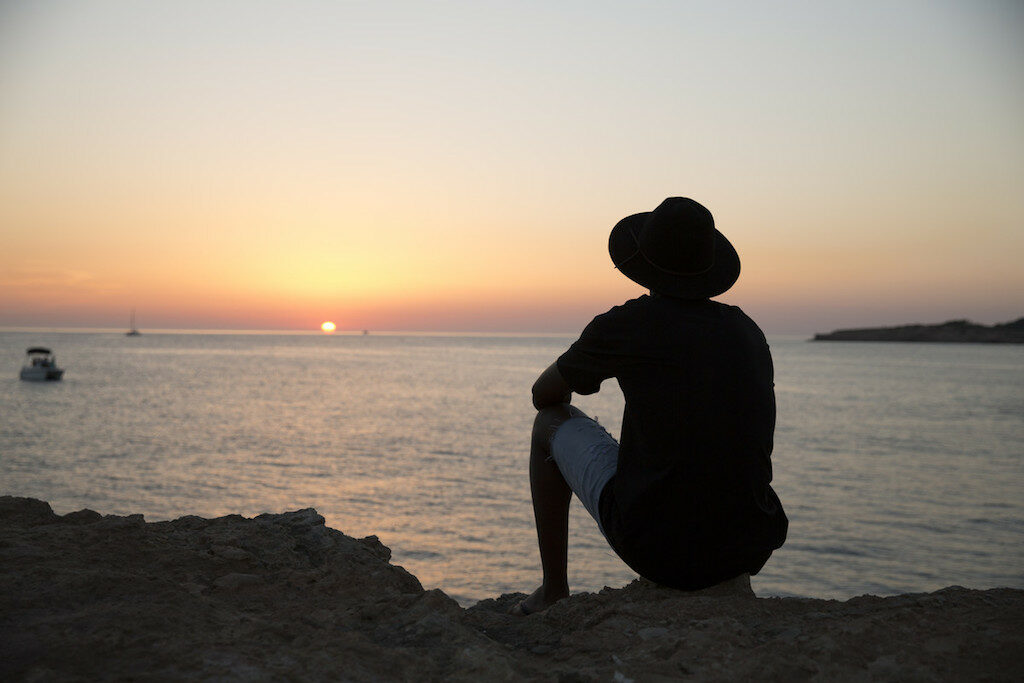 boy looking at sunset in ibiza