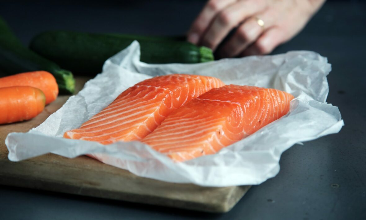 Sustainable seafood and vegetables on a cutting board.