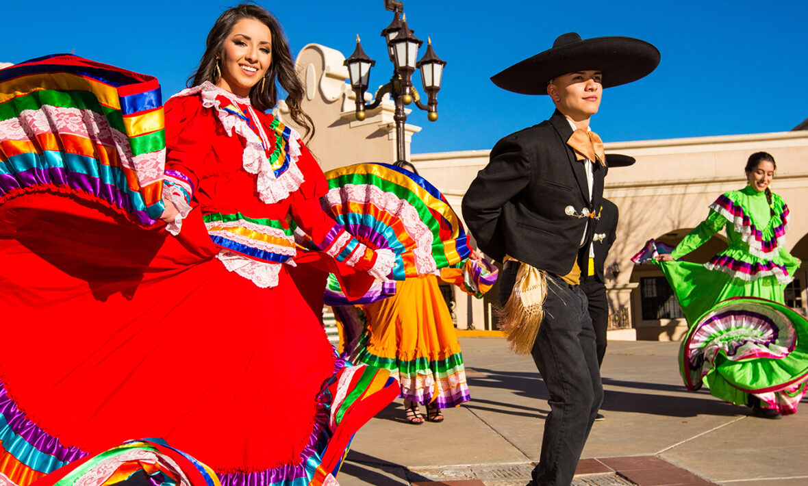 A group of Mexican dancers in colorful costumes, perfect for celebrating Cinco de Mayo.
