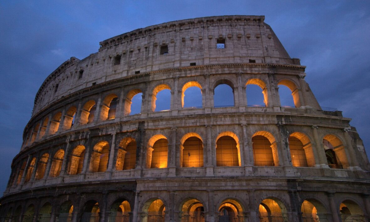         The colosseum is lit up at night.