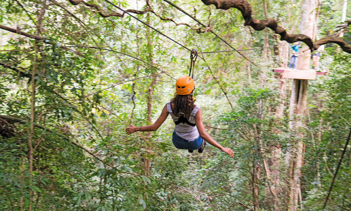 A woman on a zip line in Thailand.