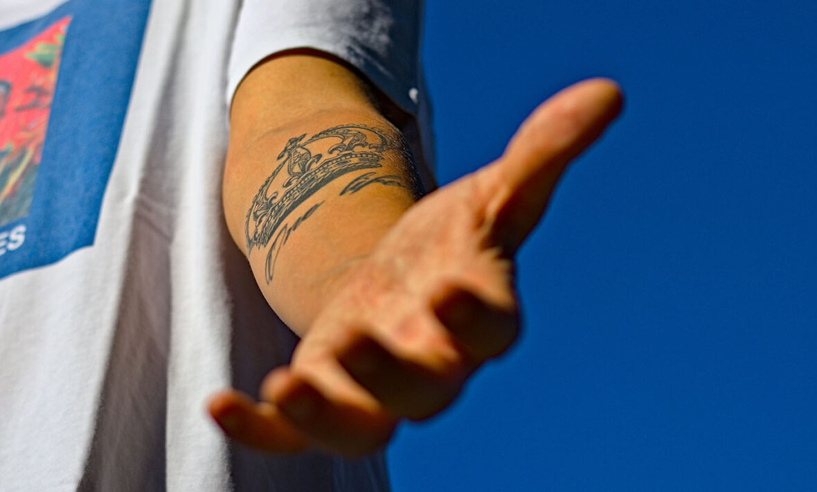 A person with a travel tattoo on his arm.