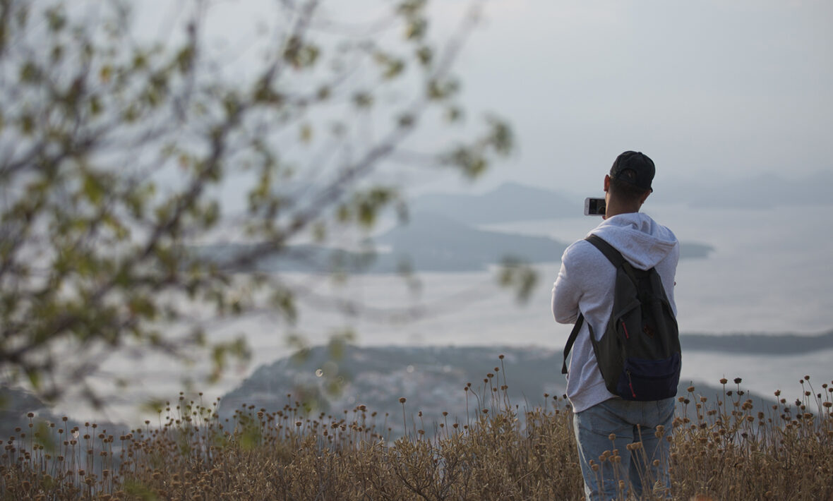 A first-time backpacker standing on top of a hill.