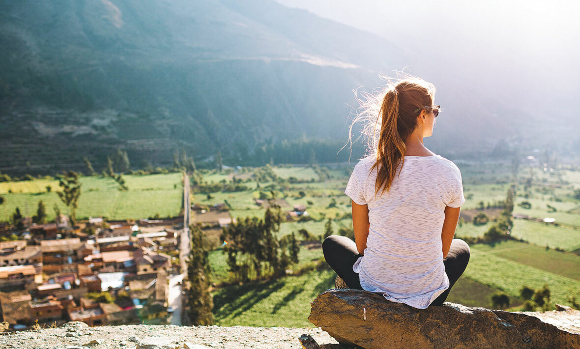 A woman is overlooking a village in South America.