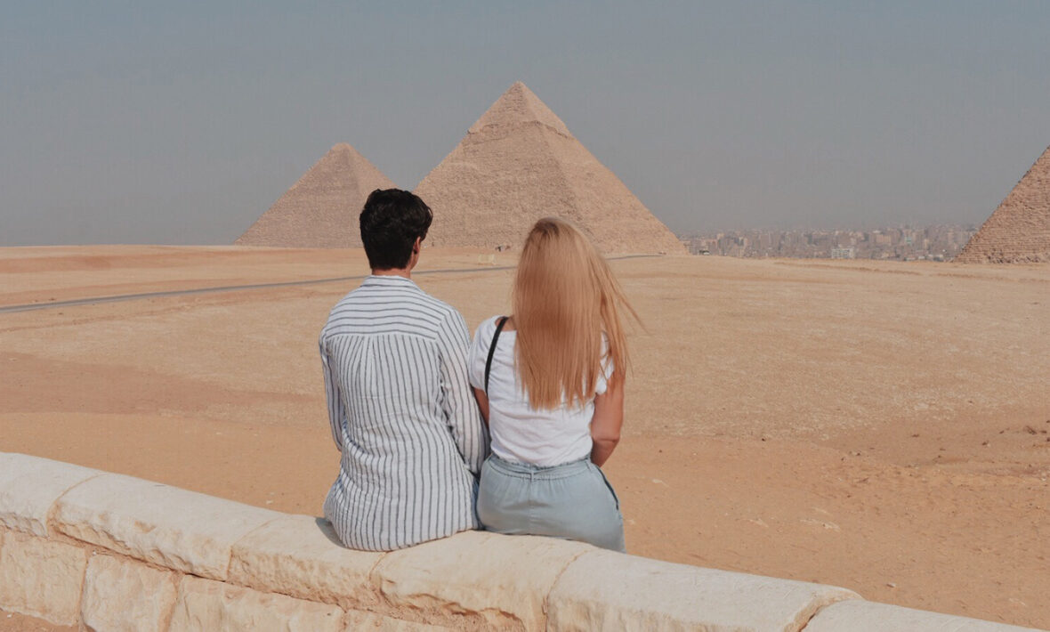 Two people looking at the pyramids in Egypt, safe for LGBT travelers.