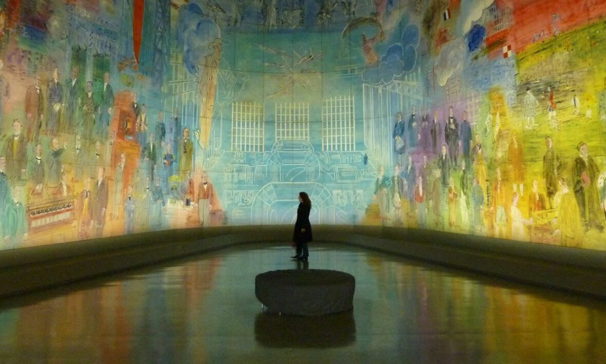An art lover standing in front of a large painting.