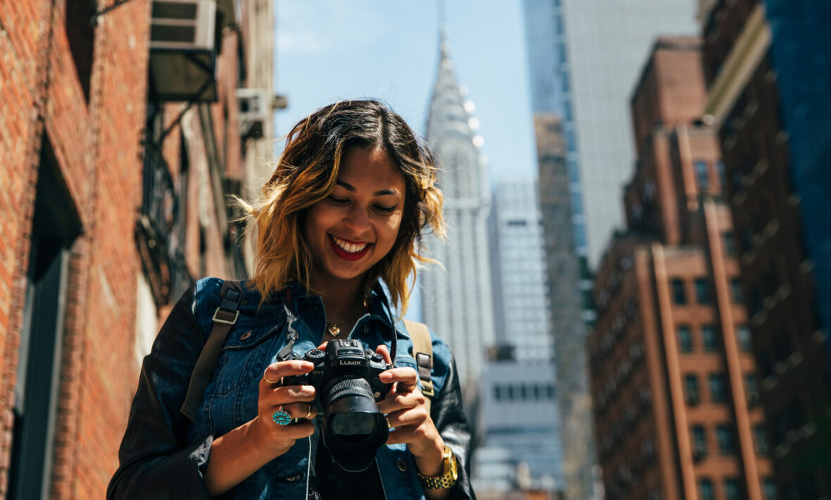 things to do in New York - image of girl looking at camera with empire state building in the background