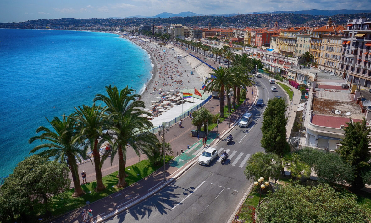 An aerial view of the beach in Nice, France showcasing nearby restaurants.