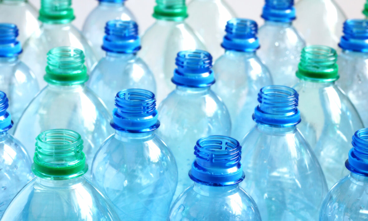 A group of blue and green plastic bottles, commonly used for beverages or other liquids.