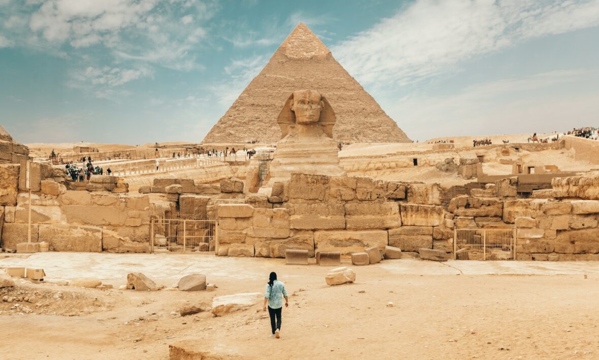 Person walking toward the Pyramids of Giza, Egypt