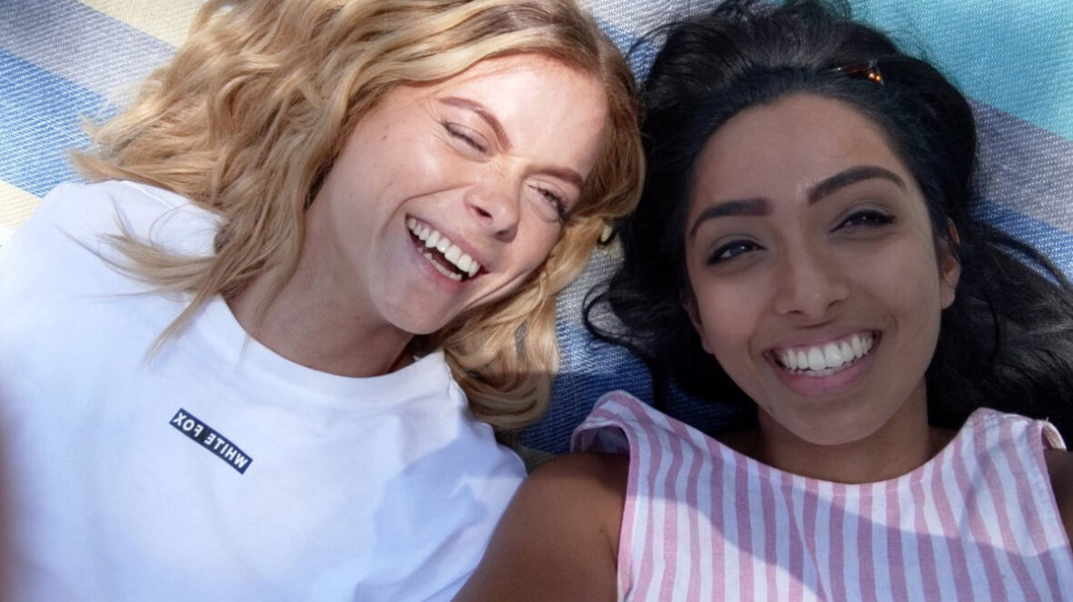 Two women keeping their mental health in check while enjoying a beach day during Covid-19.