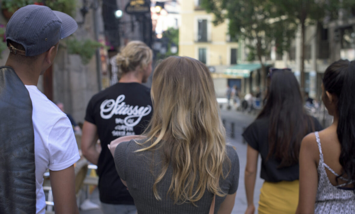 A group of travel companions walking down a street.