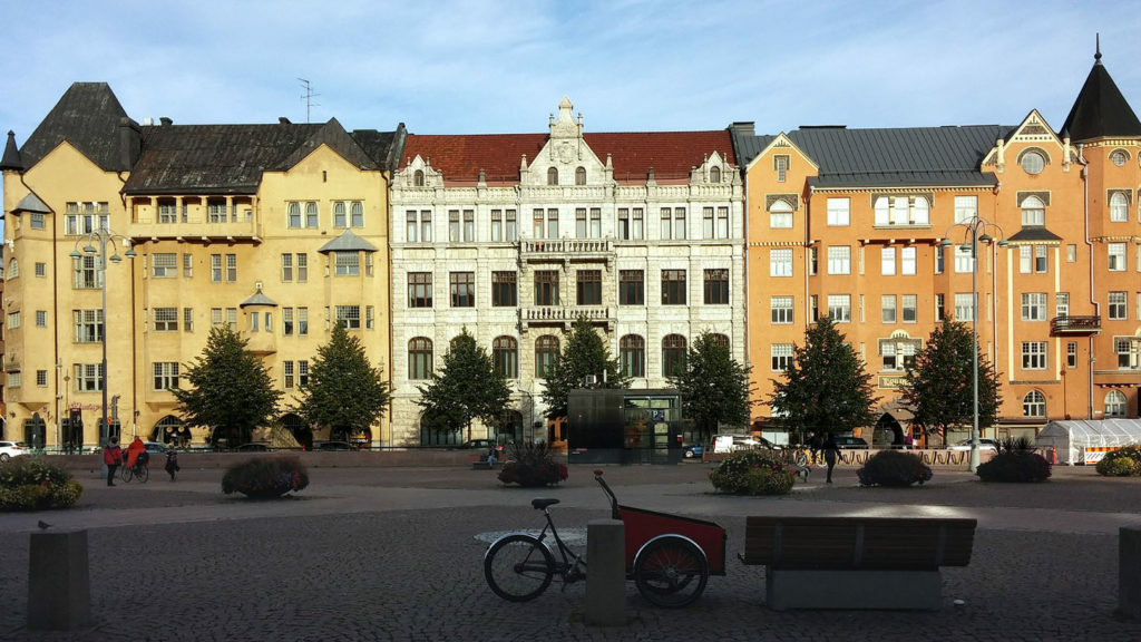 A brick building in the middle of a square to visit in Finland.