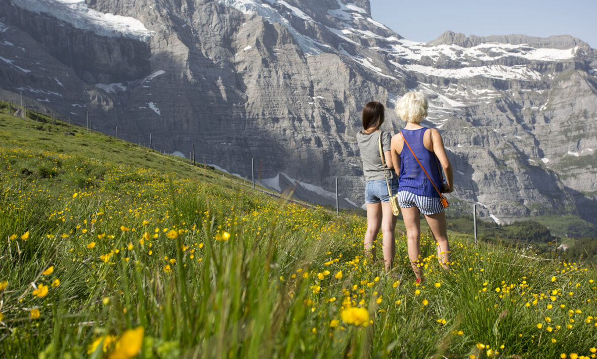 what to pack for a holiday in switzerland - image of two girls looking over the mountains in Switzerland