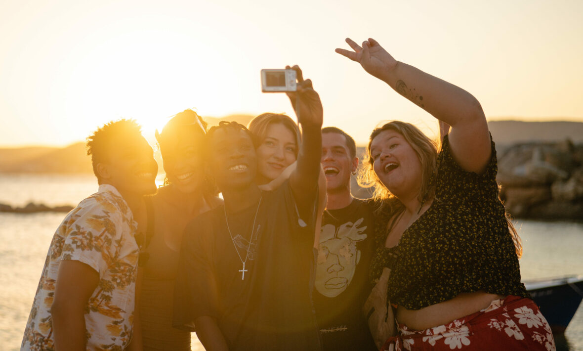 group of friends at sunset on a beach