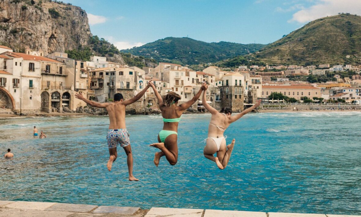 friends jumping into the water