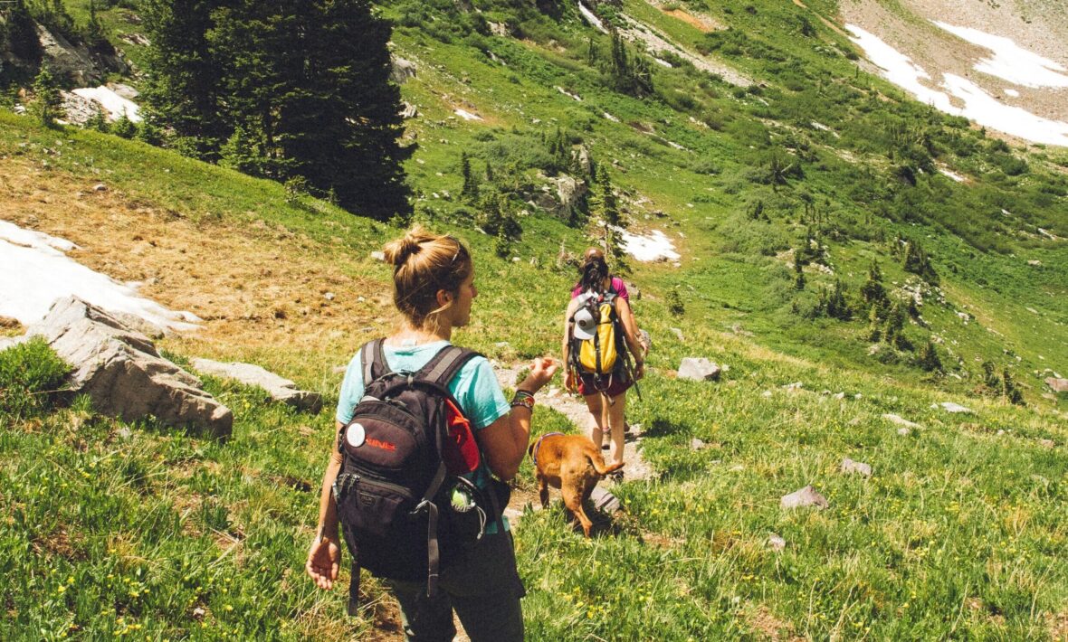 two girls hiking together in the mountains