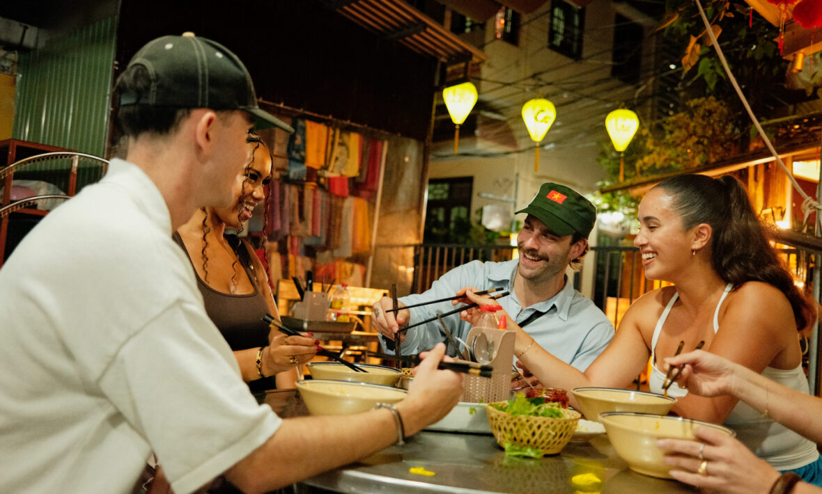Contiki travellers in Vietnam eating food