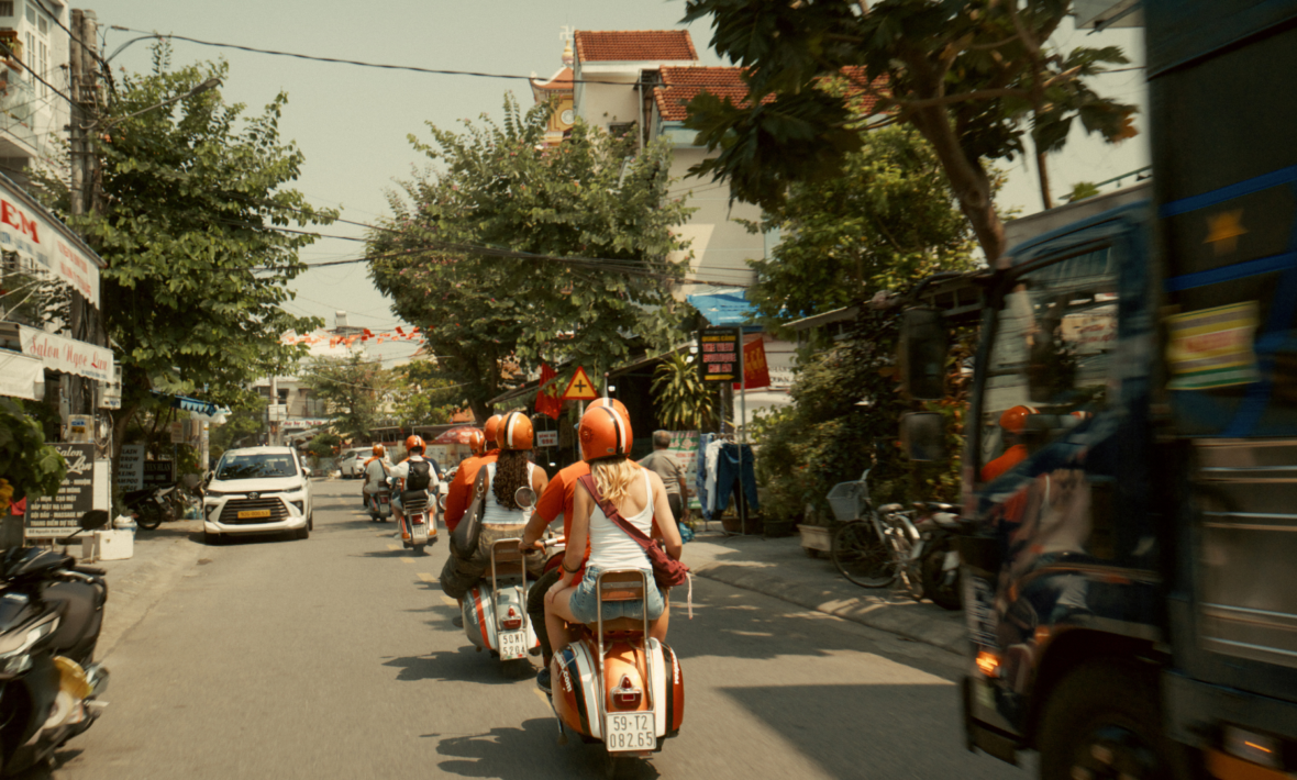 Contiki travellers on the back of vespas in Vietnam