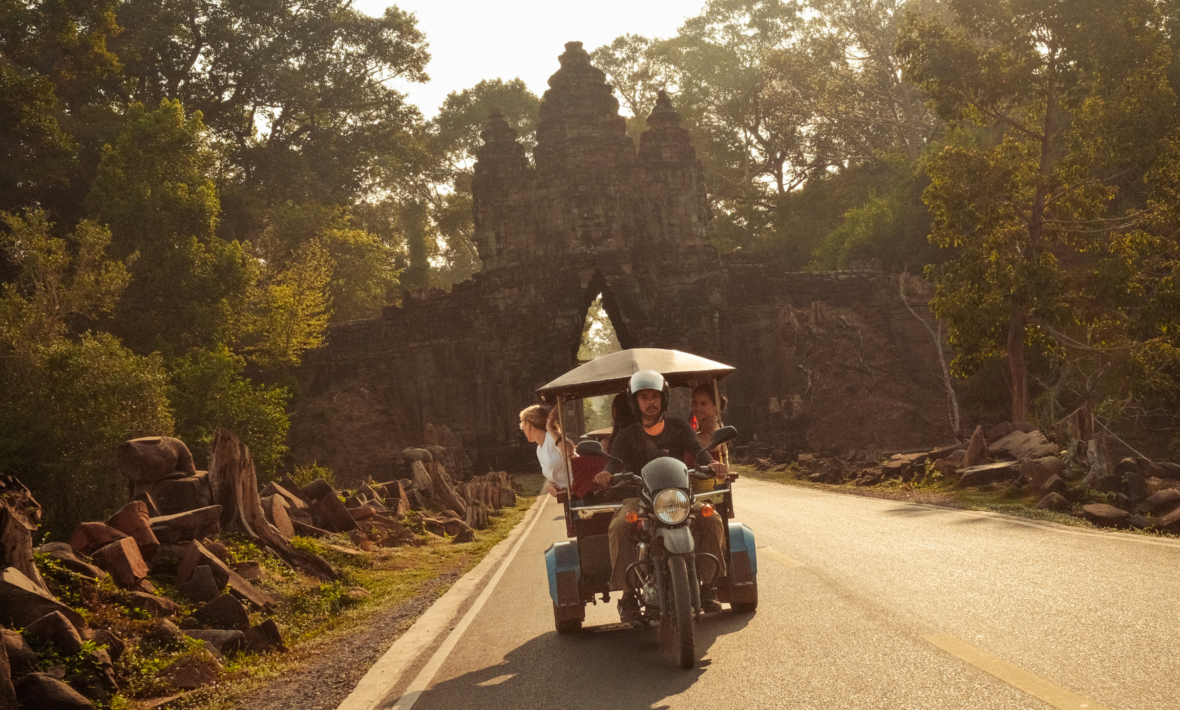 travellers on tuktuk driving through Cambodia in southeast asia