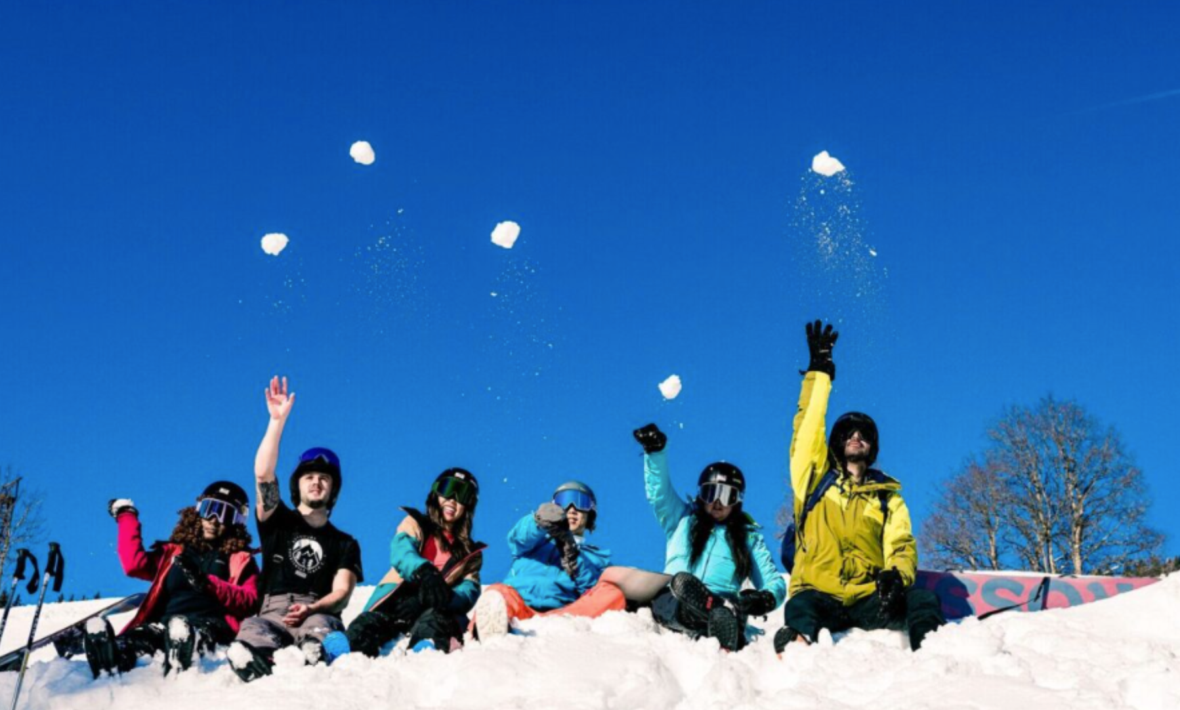 travellers throwing snowballs in air