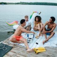 friends laughing on deck on holidays: Pexel: Ron Lach