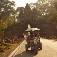 travellers on tuktuk driving through Cambodia in southeast asia