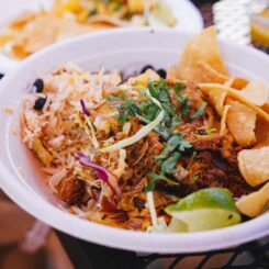 A bowl of Mexican food, known for being the best in Costa Rica, sitting on a table.