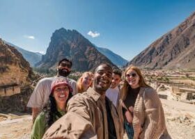 Group of young friends taking a selfie at Machu Picchu.