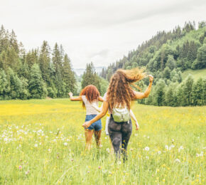 Two girls running through fields