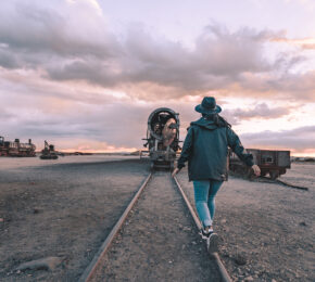 Woman walking on abandoned train tracks