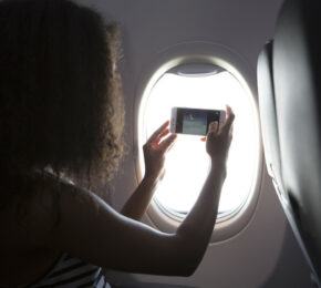 Girl taking picture on flight