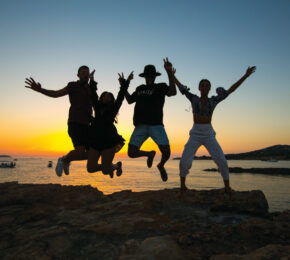 A group of first time travellers jumping in the air.