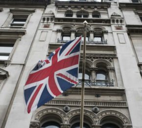 A British flag flies in front of a building in London, showcasing the country's rich music history.