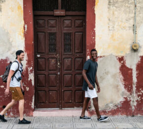 Two young men strolling through a street in Havana during their Latin America adventure with Contiki.