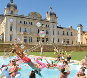 A group of people enjoying holiday hacks in a pool.