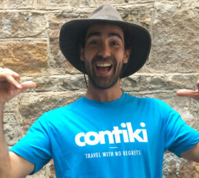 A man wearing a hat and t-shirt with the word contiki on it wins Cosmo Bachelor of the Year.