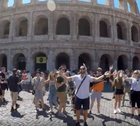 A flash mob stands in front of the colossion.