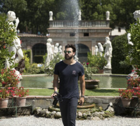 man walking with camera in garden