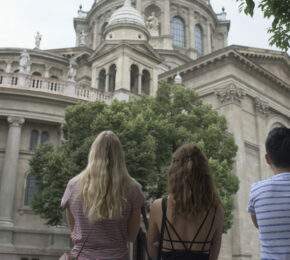 A group of people standing in front of an ornate building in Budapest.