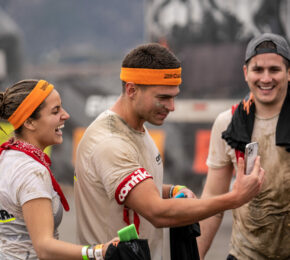 A group of people taking a selfie at Tough Mudder.