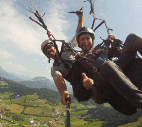 Two people paragliding over a mountain with short term memory loss.