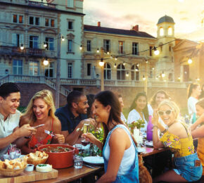 friends eating a meal on a balcony