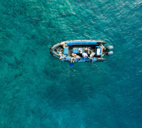 An aerial view of a boat in the ocean near Hawaii.