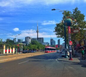 A 6ix city street with cars parked on it.