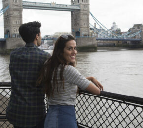 A couple traveling in the UK admiring Tower Bridge in London.