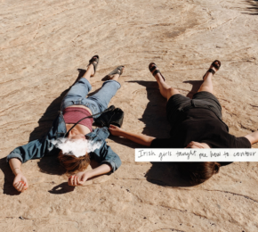 Two people laying on the ground with a quote.