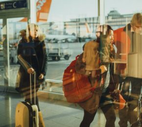 A group of people navigate the airport by themselves, walking through various terminals.