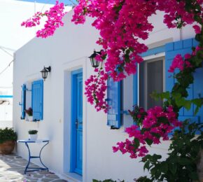 white house with blue windows in antiparos, greece