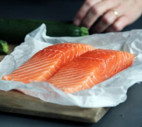 Sustainable seafood and vegetables on a cutting board.